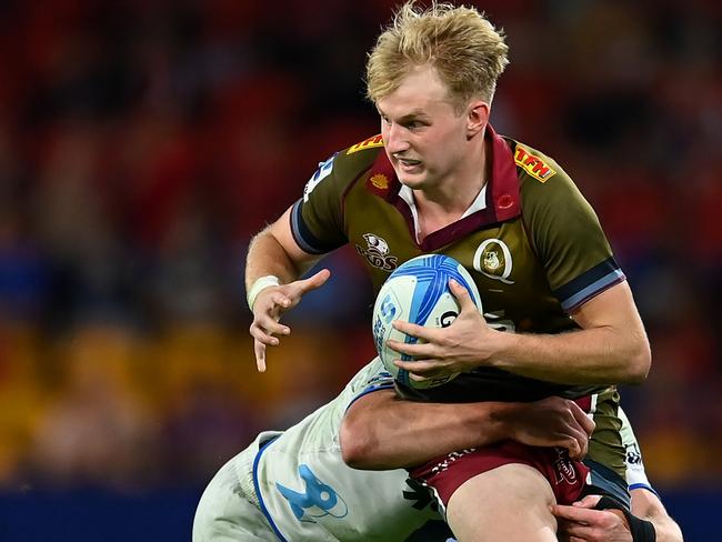 BRISBANE, AUSTRALIA - APRIL 27: Tom Lynagh of the Reds is tackled by Anton Segner of the Blues during the round 10 Super Rugby Pacific match between Queensland Reds and Blues at Suncorp Stadium, on April 27, 2024, in Brisbane, Australia. (Photo by Albert Perez/Getty Images)