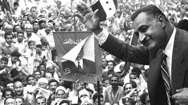 Egyptian president Gamal Abdel Nasser waves to the crowds in Mansoura, Egypt, on May 7, 1960.