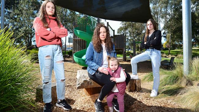 Kim Tomasello with her kids, Maddie, 12 and Mackenzie, 1, and friend Ella, 12, at their local playground, closed due to Covid restrictions. Picture: Nicki Connolly