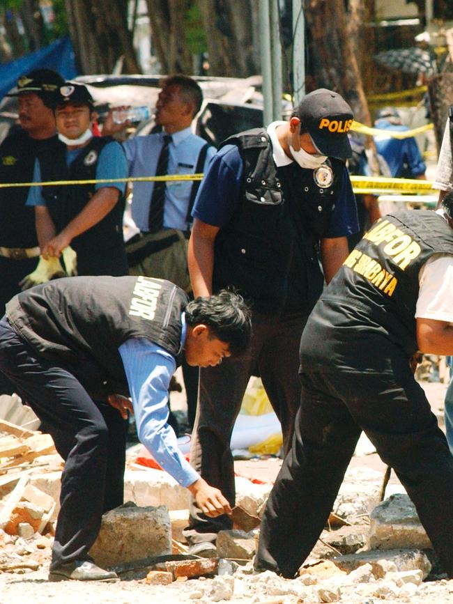 Indonesian Police investigators search through debris at the Bali nightclub bombing site. Picture: Getty Images