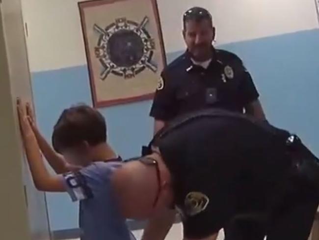 Police officers in Key West trying to handcuff a crying 8-year-old boy Credit: KWPD