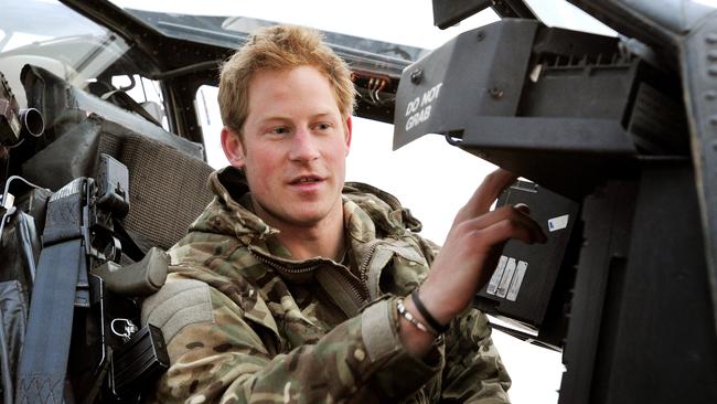 Prince Harry makes early morning helicopter pre-flight checks during his deployment to southern Afghanistan in 2012. Picture: John Stillwell