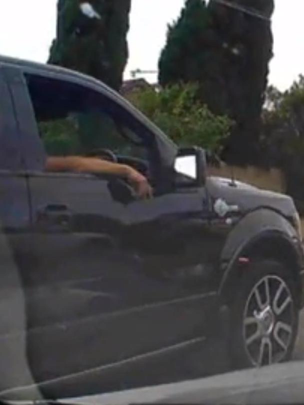 A man tosses a lit cigarette out of his car window in Hurstville last month during a total fire ban. Picture: YouTube