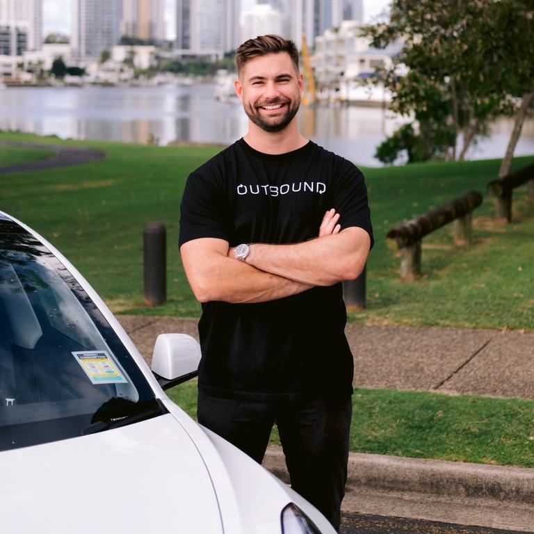 Outbound chief executive Luke Rust with a communal Tesla. Picture: Supplied