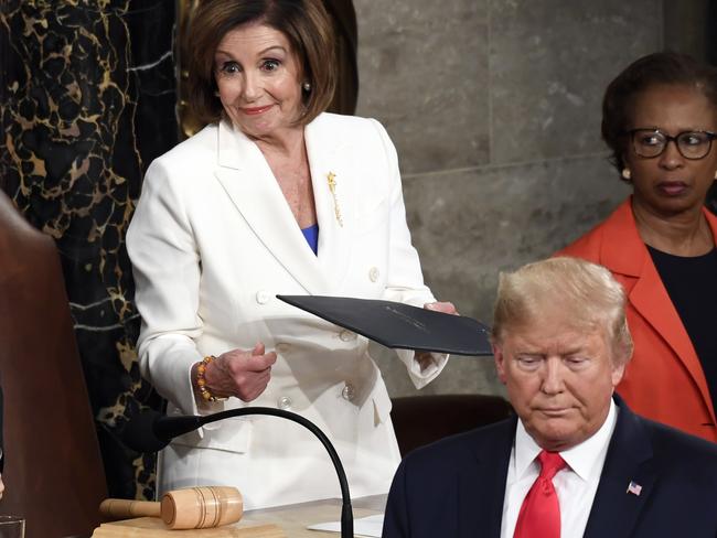 President Donald Trump turns after handing copies of his speech to House Speaker Nancy Pelosi. Picture: Susan Walsh