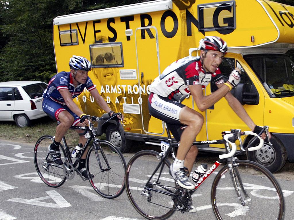 Lance Armstrong is riding up a steep hill.