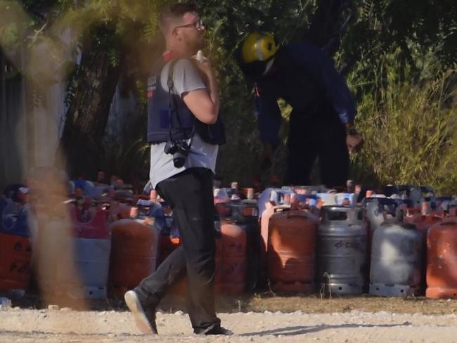 A policeman walks past dozen of gas bottles in Alcanar during a search linked to the Barcelona and Cambrils attacks on the site of an explosion on August 18. Picture: AFP