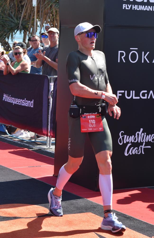 Athletes crossing the finish line at Sunshine Coast Ironman 70.3 2023.