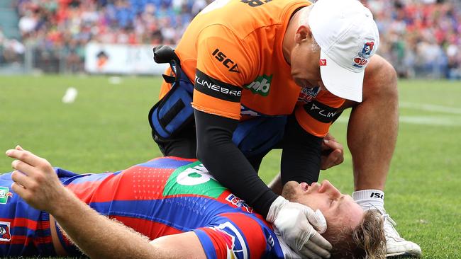 Brendan Elliot is treated during the Knights’ clash with the Rabbitohs.