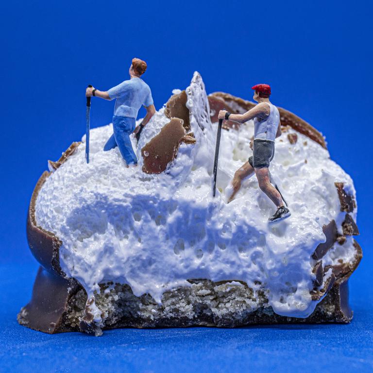 During the Covid lockdown, British photographer Jacki Gordon snapped tiny model railway figures with everyday items - usually food - to entertain friends and family online. After biting into a tea cake, its snowy marshmallow centre became the perfect terrain for some tiny Nordic walkers. Picture: Jacki Gordon/Pink Lady® Food Photographer of the Year