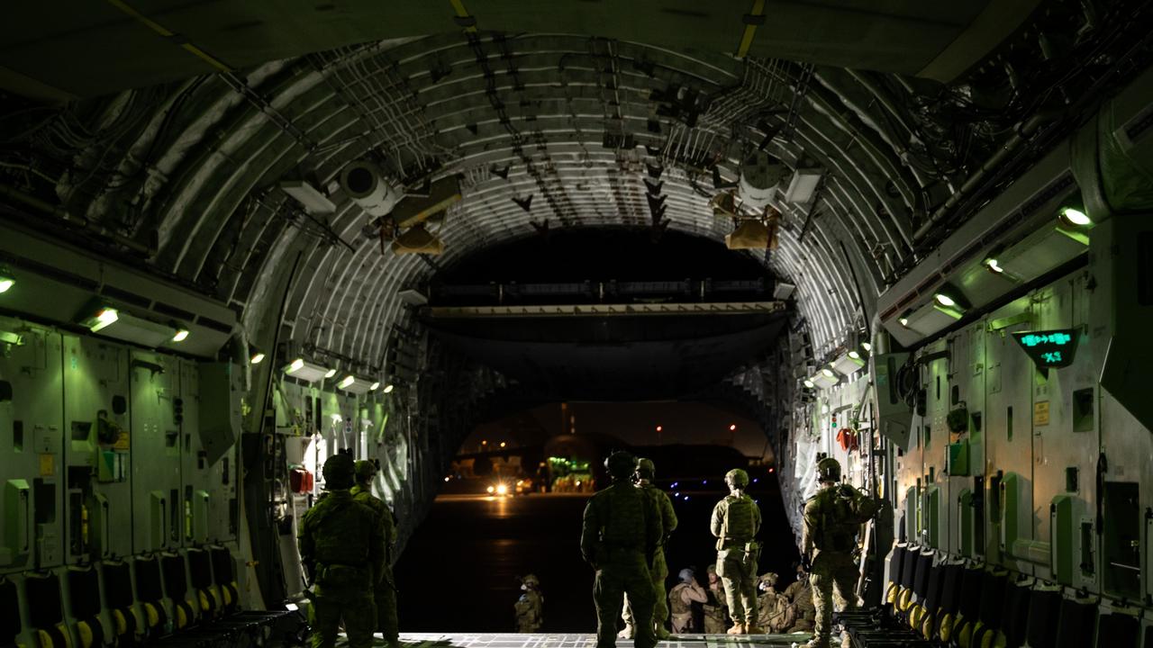 Royal Australian Air Force personnel unload cargo and prepare to receive evacuees onto a RAAF C-17A Globemaster, on the flight line of Hamid Karzai International Airport. Picture: Defence