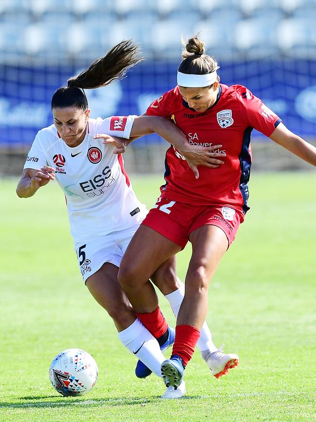 Amber Brooks of Adelaide United tackles Talitha Kramer of the Wanderers...