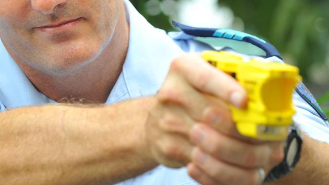 A police officer with a taser.