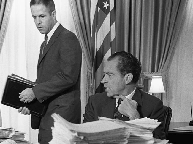 President Richard M. Nixon sits behind a mound of papers as he speaks with his chief of staff, H.R. Haldeman, in the White House. Picture: Getty