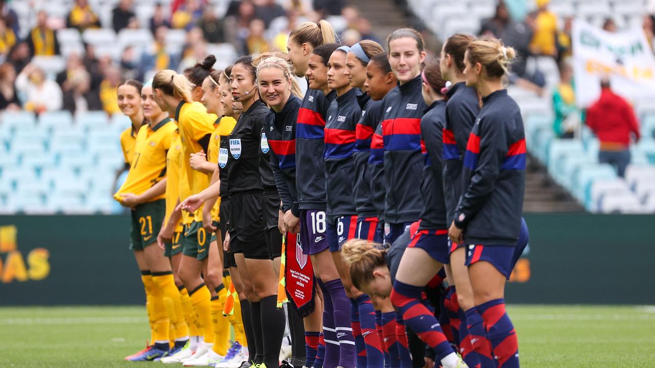 Australia and the US stand together before the start of their women football match at Stadium Australia in Sydney on November 27, 2021. Photo: AFP