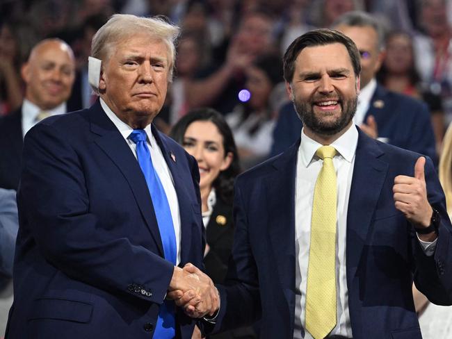 TOPSHOT - US Senator from Ohio and 2024 Republican vice presidential candidate J.D. Vance (R) gives a thumbs up as he shakes hands with US former President and 2024 Republican presidential candidate Donald Trump during the second day of the 2024 Republican National Convention at the Fiserv Forum in Milwaukee, Wisconsin, July 16, 2024. Days after he survived an assassination attempt Donald Trump won formal nomination as the Republican presidential candidate and picked right-wing loyalist J.D. Vance for running mate, kicking off a triumphalist party convention in the wake of last weekend's failed assassination attempt. (Photo by Jim WATSON / AFP)