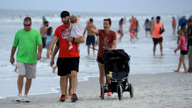 People walk along a beach in Jacksonville, Florida, in April. Picture: AFP