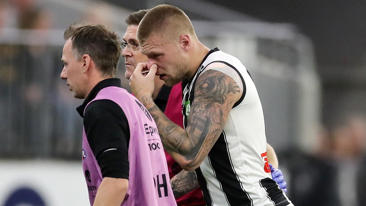 Jordan De Goey leaves the field after the heavy knock against West Coast. Picture: Will Russell/AFL Photos via Getty Images