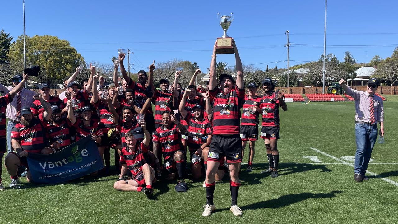 Gatton Black Pigs C-grade captain Angus Brennand lifts the trophy in the air on Downs Rugby grand final day.