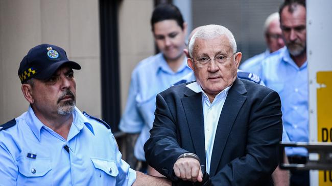 Ron Medich is bundled into a prison van after Monday’s conviction.