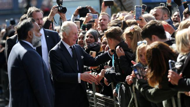 King Charles III talks on Saturday with people waiting in the queue to pay their respects to Queen Elizabeth II, Lying-in-State at the Palace of Westminster. Picture: AFP