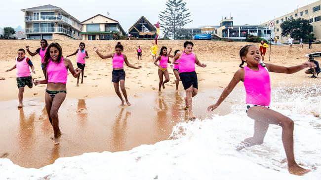 Kids from the outback run into the ocean at South Narrabeen. Picture: Monique Harmer.