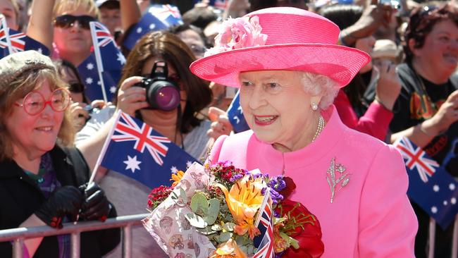 Queen Elizabeth II receives flowers from the crowd during her visit to Federation Square in 2011. Picture: AFP