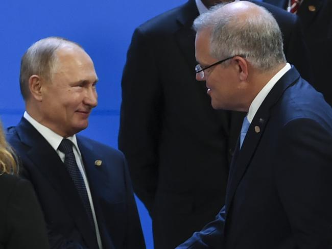 Australian Prime Minister Scott Morrison (right) shakes hands with President of Russia Vladimir Putin ahead of the family picture at the G20 summit in Buenos Aires, Argentina, Friday, November 30, 2018. The leaders of the world's largest economies arrived in Buenos Aires on Thursday for the first G20 summit to be held in South America. (AAP Image/Lukas Coch) NO ARCHIVING