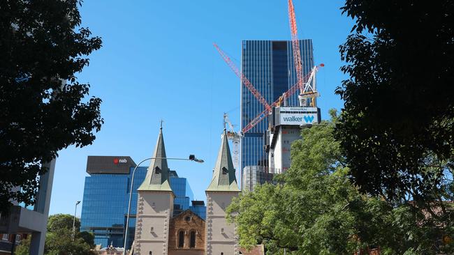 Old and new: Construction of Parramatta Square in April dwarfs St John’s Anglican Cathedral, with NAB headquarters to the left and 6 and 8 Parramatta Square towering above to the right. Picture: Angelo Velardo