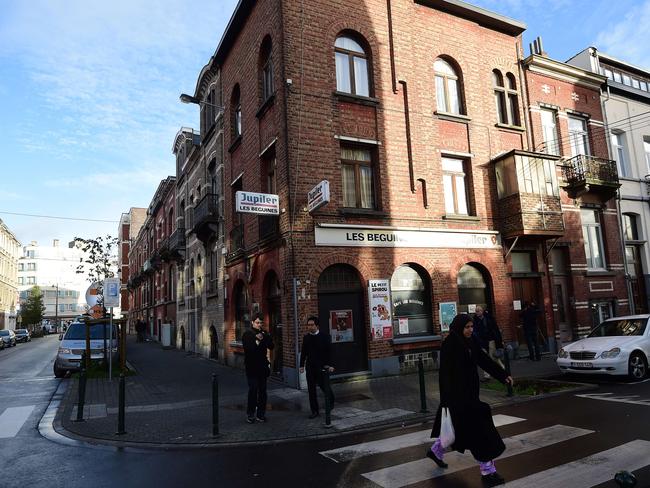 Family ties ... A woman walks past the "Les Beguines" bar in Brussels's Molenbeek district, owned by Ibrahim Abdeslam, one of three brothers implicated in Paris attacks. Source: AFP