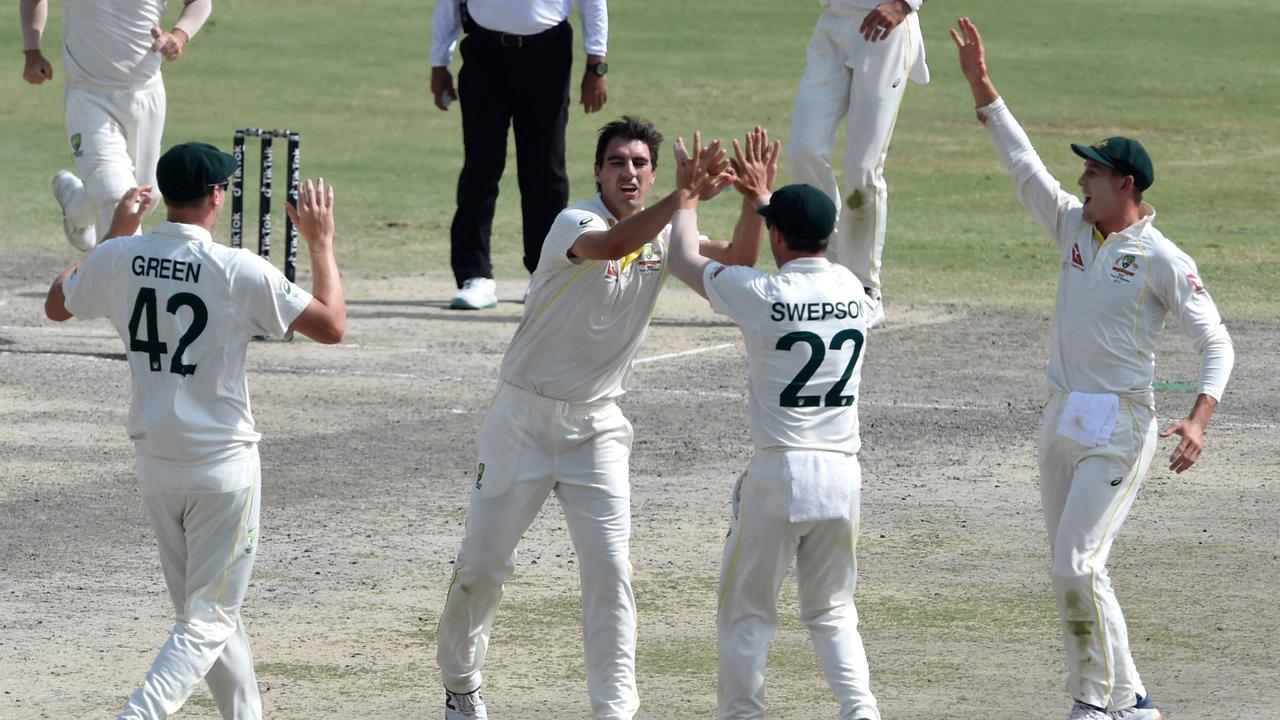 Australia's captain Pat Cummins (C) celebrates with teammates after taking the wicket of Pakistan's Fawad Alam (not pictured) during the fifth and last day of the third and final Test cricket match between Pakistan and Australia at the Gaddafi Cricket Stadium in Lahore on March 25, 2022. (Photo by Arif ALI / AFP)