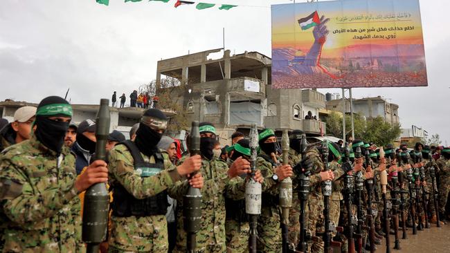 Hamas fighters gather at the site of the handing over in Rafah. Picture: AFP