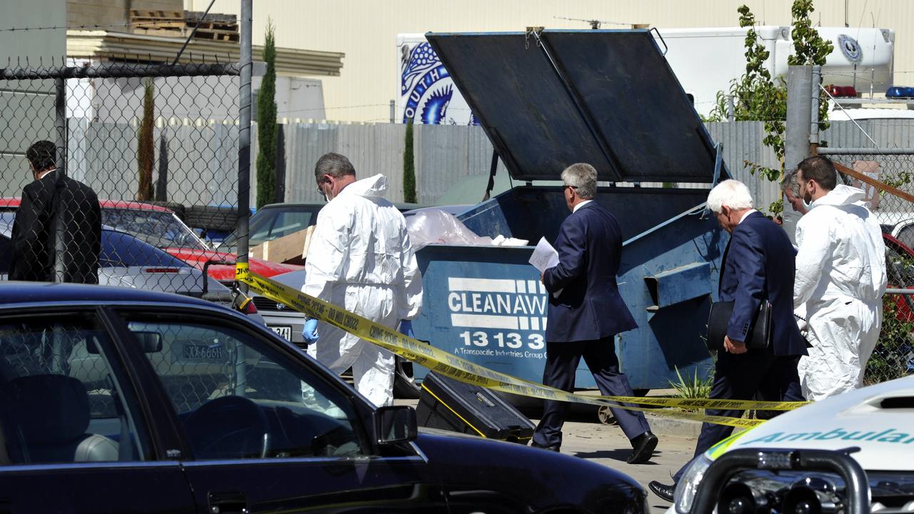 Detectives and forensic experts investigate the crime scene after the shooting of Jason De Ieso.