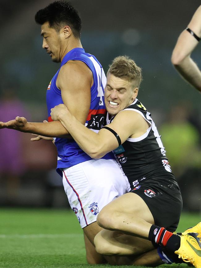 Jack Lonie runs down Bulldog Lin Jong. Picture: Michael Klein