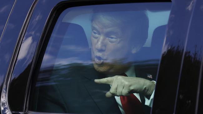 Donald Trump waves to supporters as he travels to his Mar-a-Lago estate yesterday. Picture: Getty Images