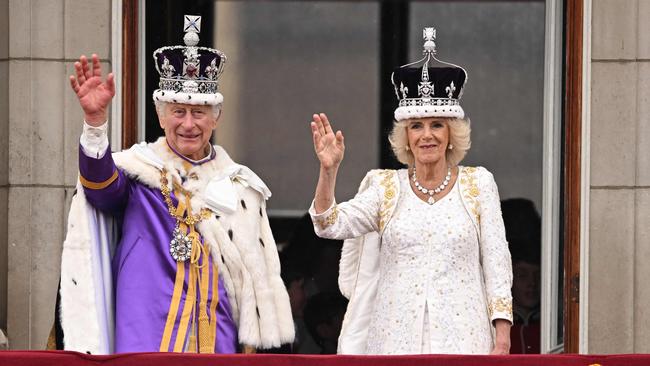 King Charles III and Queen Camilla wave from the Buckingham Palace balcony after their coronations. Picture: Oli Scarff / AFP