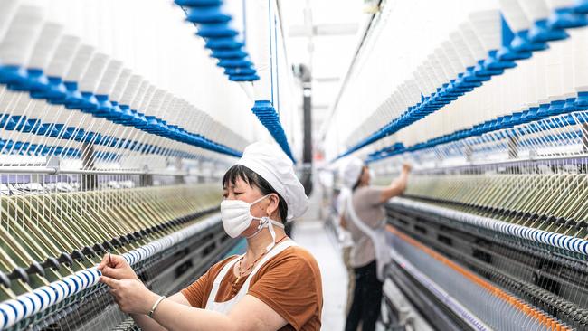 An employee works at a textile factory in Nantong, in China's eastern Jiangsu province on July 15.