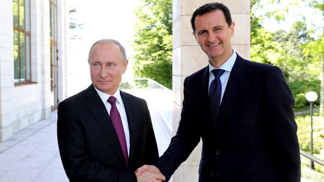 Russian President Vladimir Putin (L) shakes hands with his Syrian counterpart Bashar al-Assad during their meeting in Sochi in 2018.