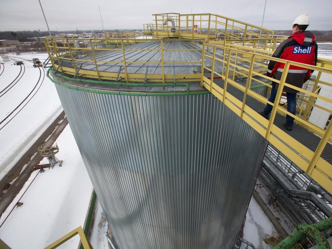 A worker walks towards the roof of a storage silo containing base oil at the Royal Dutch Shell Plc lubricants blending plant in Torzhok, Russia, on Tuesday, March 1, 2016. Royal Dutch Shell Plc has surpassed Chevron Corp. as the world's second-biggest non-state oil company after completing the acquisition of BG Group Plc. Photographer: Andrey Rudakov/Bloomberg