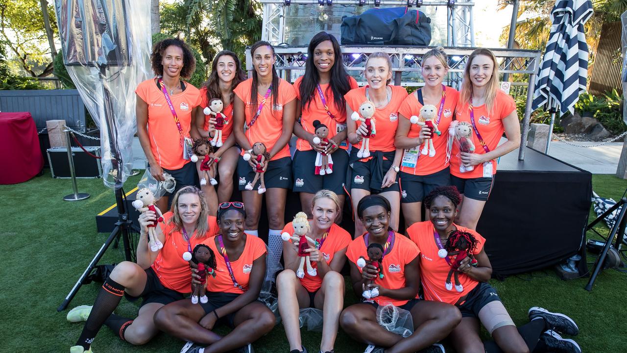 The England Roses netball team pose with their crocheted “lookalikes”.