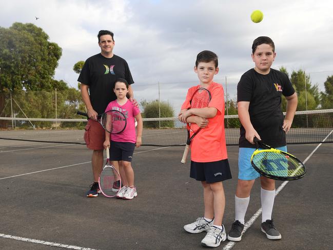 16/2/17 -  Travis Smith and his family are opposing Marion Council plans to carve up McConnell Reserve's tennis courts in Marino, as part of a plan to rip up underused courts throughout the district. Travis is pictured with his twins Maeve and Angus (orange t-shirt), 8 and neighbour Patrick Wesson, 12 (black t-shirt). Photo Naomi Jellicoe