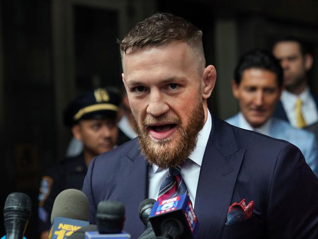 (FILES) This file photo taken on July 26, 2018 shows Irish mixed martial arts superstar Conor McGregor talking to the press after he pleaded guilty to a single violation of disorderly conduct, in Brooklyn Criminal Court. - Mixed martial arts superstar Conor McGregor announced his retirement from the sport on June 7, 2020. (Photo by TIMOTHY A. CLARY / AFP)