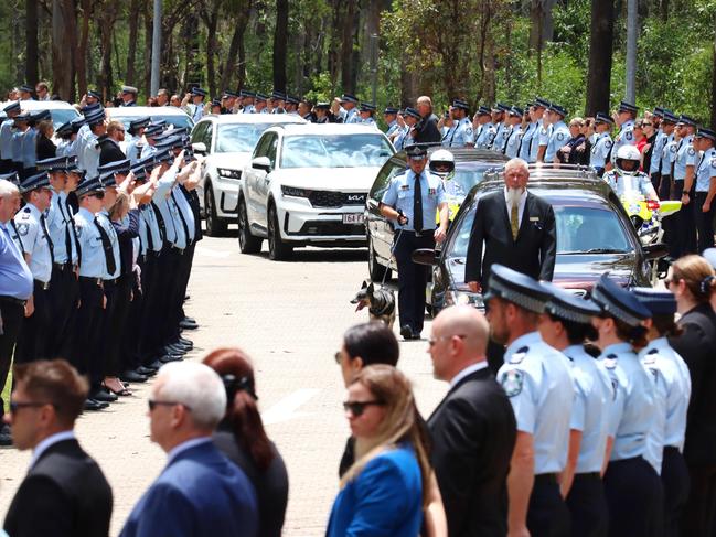 A hearse passes the guard of honour at the memorial service with full police honours for constables Rachel McCrow and Matthew Arnold at Brisbane Entertainment Centre. Picture: David Clark