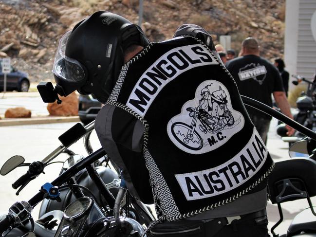 Members of the Mongols outlaw motorcycle club fuel up in Alice Springs before being stopped by police on the Stuart Hwy on a run to Darwin on October 12, 2022. Picture: Jason Walls