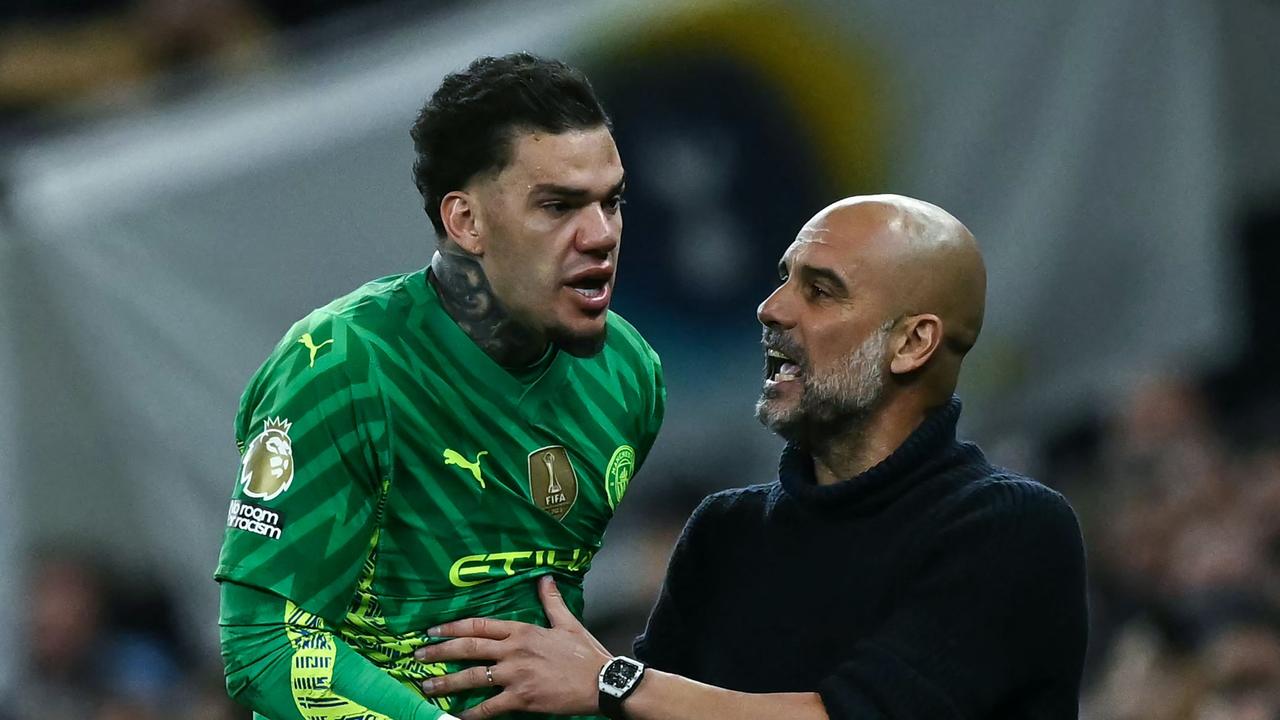 Manchester City's Brazilian goalkeeper #31 Ederson (L) argues with Manchester City's Spanish manager Pep Guardiola following his decision to substitute him. Photo by Ben Stansall / AFP.