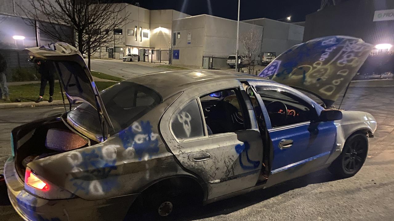 ACT Police are looking for the alleged driver of a gold Ford Falcon sedan covered in graffiti (pictured), who is described as wearing a banana costume and a balaclava at the time. Picture: Supplied / ACT Police