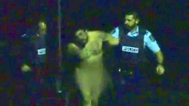 Police arrest the nude intruder. Picture: Seven News