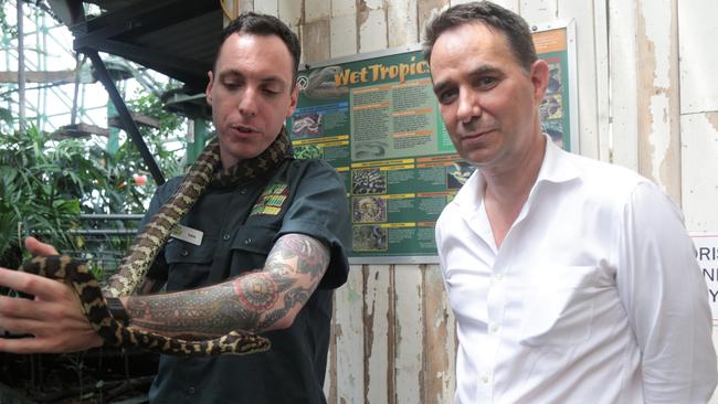 Cairns Wildlife Dome snake handler Dan Kemp and Cairns Hospital infectious disease physician Josh Hanson with Grug the carpet python. Picture: Peter Carruthers