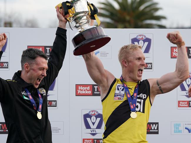 Tigers head coach Craig McRae (left) and Steve Morris hold the 2019 VFL premiership cup after winning the VFL grand final. Picture: Scott Barbour