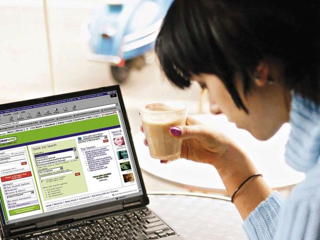 LIBRARY: Undated : Generic photo of job seeker takes break with cup of coffee while looking through News Limited's CareerOne section of newspaper while it's web site is displayed on laptop computer. Unemployment